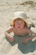 Baby girl plays with a sand