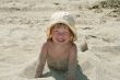 Baby girl plays with a sand