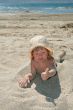 Baby girl plays with a sand