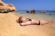 model lying on the beach