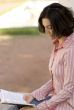 female reading in park