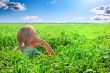 Relaxing girl on meadow against the blue sky