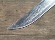 silver knife blade on wood
