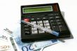 Calculator, pen and banknotes