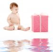 baby boy in diaper with big gift box