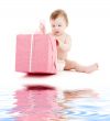 baby boy in diaper with big gift box