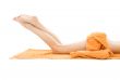 long legs of relaxed lady with orange towel
