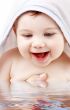 happy baby with terry hoodie robe on head