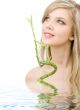 blue-eyed blonde with bamboo in water