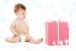 baby boy in diaper with big gift box and snowflakes