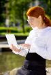 businesswoman with laptop in the park