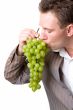 man eats green grapes