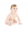 baby boy in diaper with toothbrush sticking tongue out