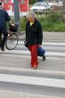 Old woman crossings a road