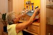 Old woman cleans their trophies.