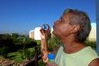 Old woman makes soap bubbles.