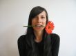 dark hair girl bitting a flower