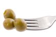Green olive on fork