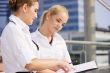 two happy businesswomen with paper chart