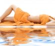 torso of relaxed lady with orange towels