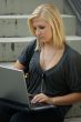 Young, blonde girl with laptop.