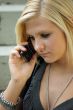 Young, blonde girl with a mobile phone.