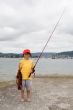 Child fisherman with red hat