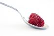 red raspberries in silver spoon