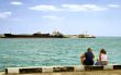 Summer day man and woman sitting at the berth