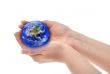 joined female hands holding globe
