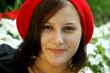 Portrait of a young girl with red cap.