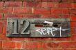 Mail box on red brick wall covered with graffiti