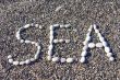 word sea made of white stones