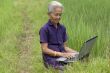 Old Asian with laptop