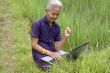 Old Asian with laptop