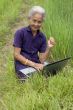 Old Asian with laptop