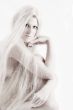Long blond haired artistic beauty checking you out