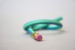 Green rubber pencil twisted into a knot
