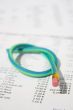 Green rubber pencil twisted into a knot