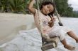 Girl on swing at the sea