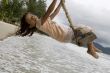 Girl on swing at the sea
