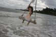 Girl on swing at the sea