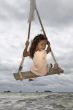 Girl on swing at the sea