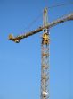 yellow construction crane in the blue sky