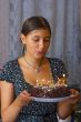 girl blows into candles