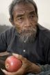 old asian man with apple