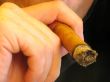 male hand holding a cigar
