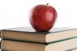 A red apple on top of books