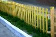Yellow fence and the green grass