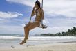 Girl on swing on the beach